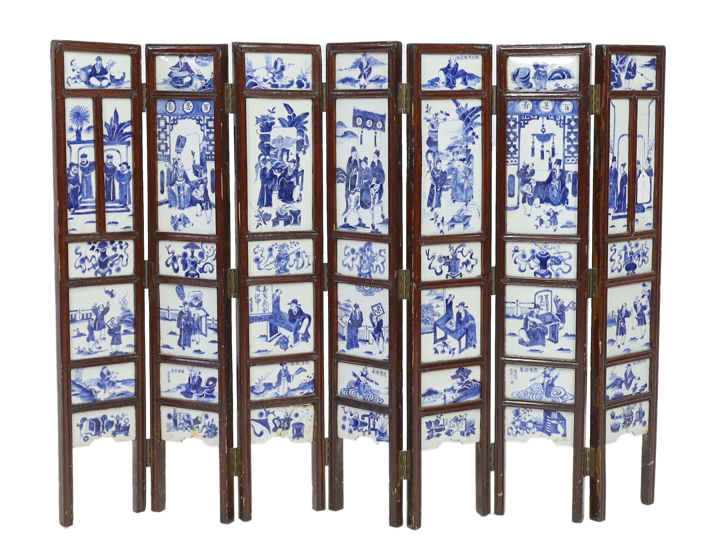 A Chinese blue and white panelled seven-fold low screen, late 19th/early 20th century, some cracked panels